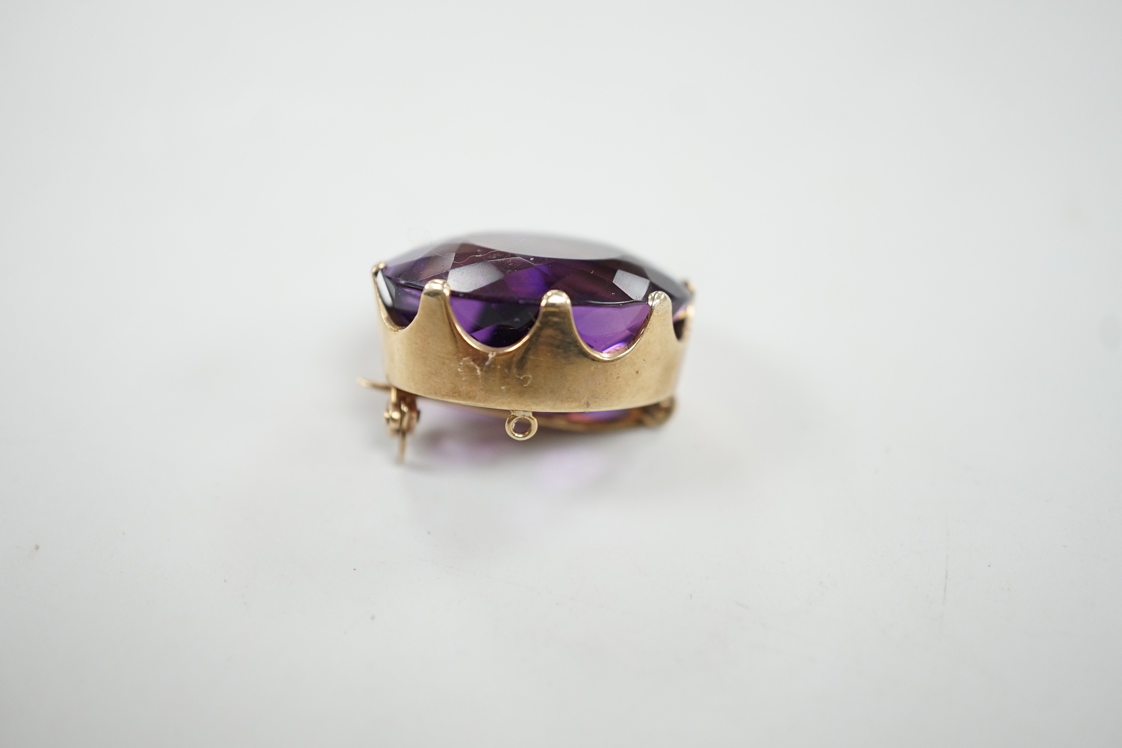 A modern 9ct gold mounted oval facet cut amethyst brooch, 22mm, gross weight 8.5 grams.